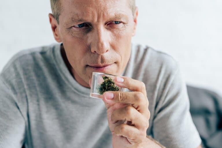 adult man smelling medical cannabis