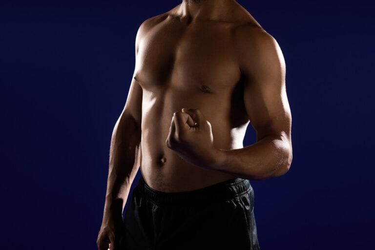 black man athletic build flexing muscles